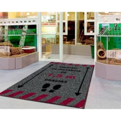 ALFOMBRA PARA SUELO DE PASO NOVUS MANTEN DISTANCIA DE 1,5 M GRACIAS FONDO GRIS 85X150 CM