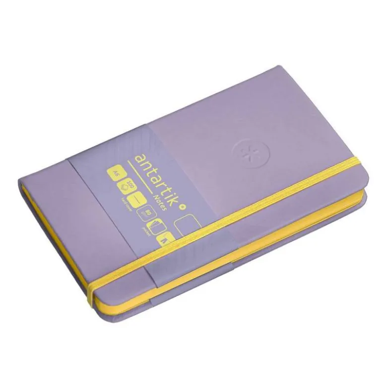 CUADERNO CON GOMILLA ANTARTIK NOTES TAPA DURA A6 HOJAS LISAS MORADO Y AMARILLO 100 HOJAS 80 GR FSC